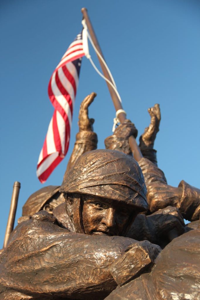 Bronze statue depicting soldiers raising the American flag.